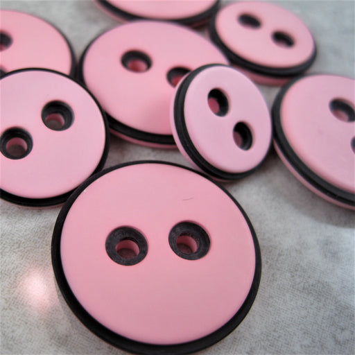 Pink button with black edging