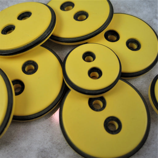 Yellow button with black edging