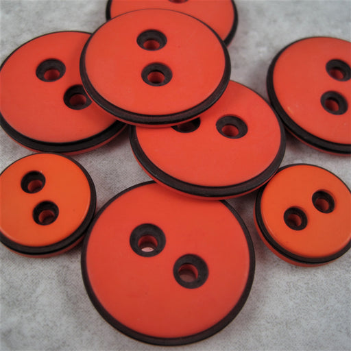Orange button with black edging