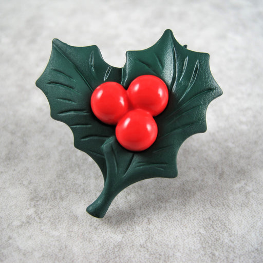 Christmas holly button with red berries.