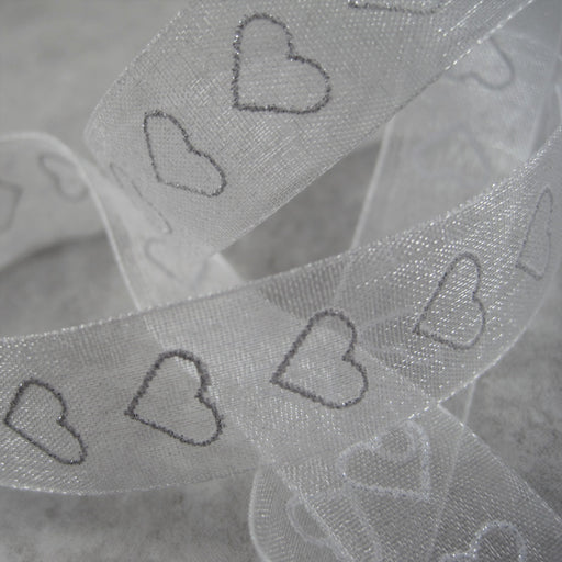 Sheer white  Ribbon with sparkly, silver, heart motif.