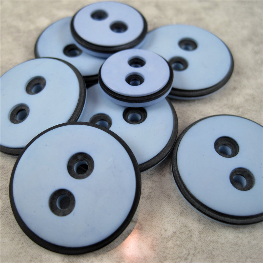 Pale blue button with black edging