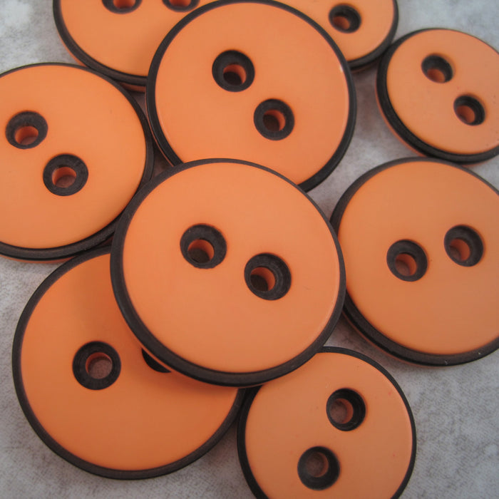 Pale Orange button with black edging
