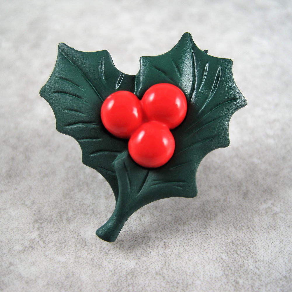 Christmas holly button with red berries.