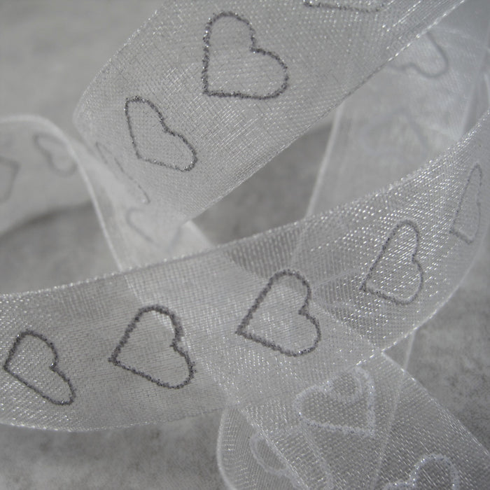 Sheer white  Ribbon with sparkly, silver, heart motif.
